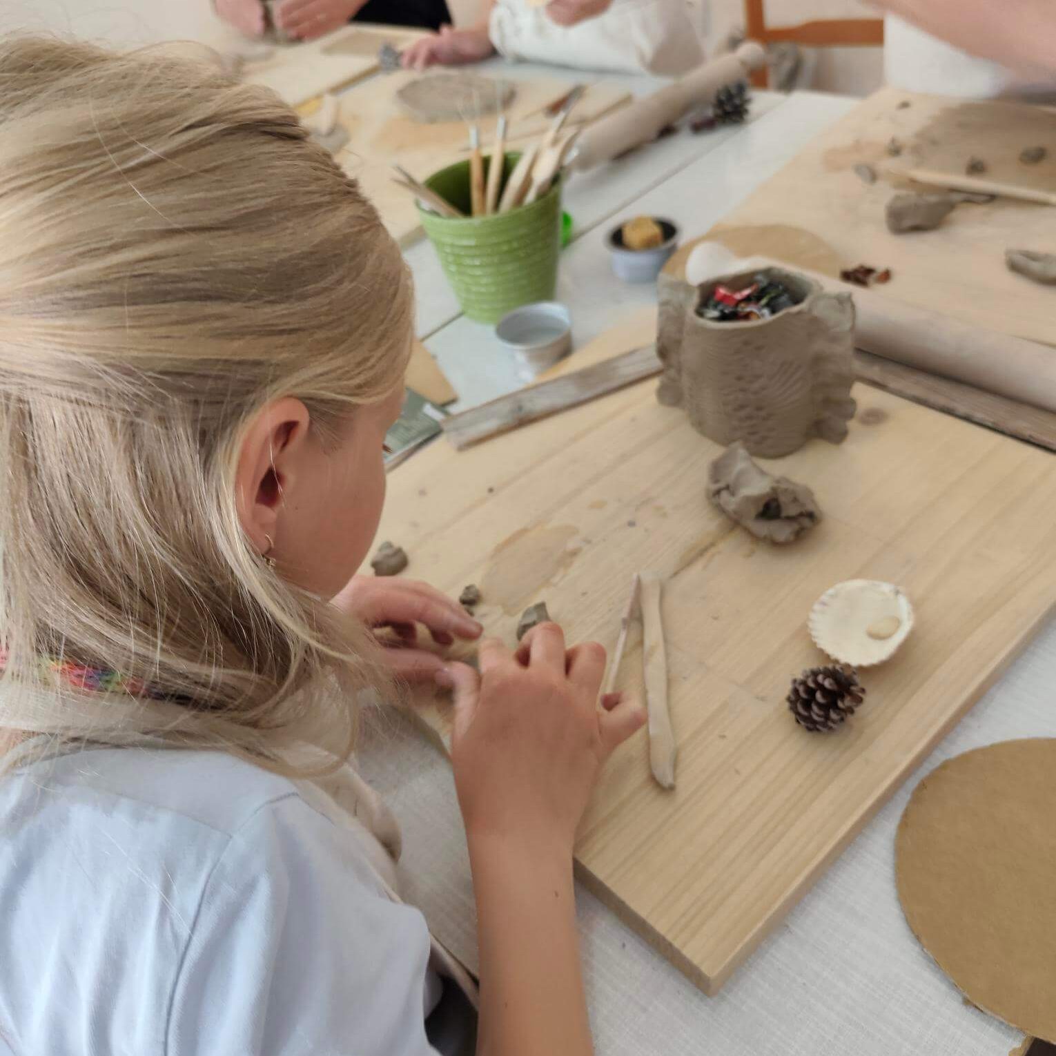 Návštevníci modelú z hliny.